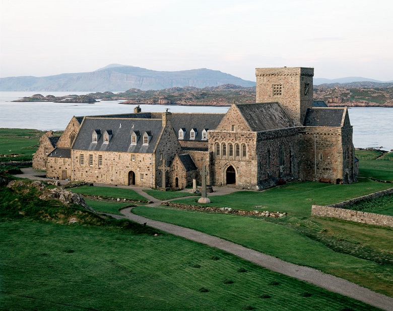 The extensive buildings of Iona Abbey with the sea and mountains in the background