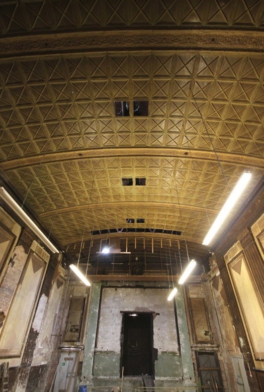 Interior of a former cinema with an ornate ceiling 
