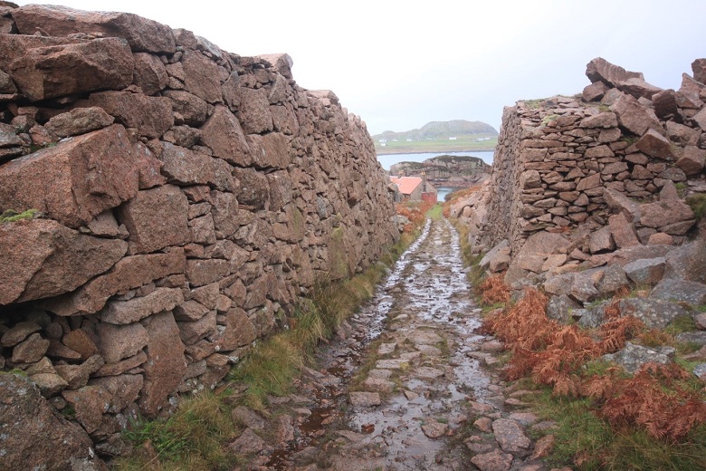 A stone path leading between two walls cut into the rock at a quarry