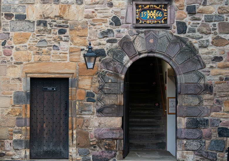 A stone dating from 1566 in a lintel above a doorway in Crown Square at Edinburgh Castle