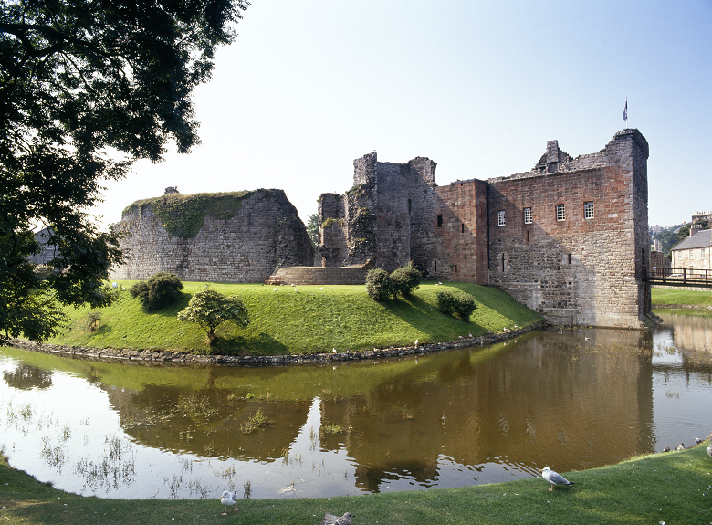 The ruins of Rothesay Castle, with its distinctive circular wall reflected in the moat 