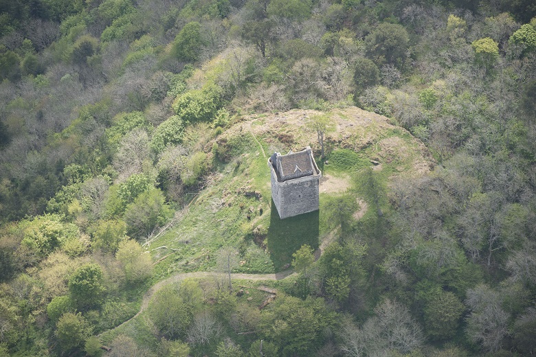 Aerial view of paths leading through moorland to a well-preserved tower house