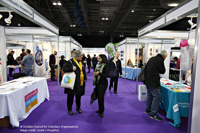 delegates chat at an exhibition stand