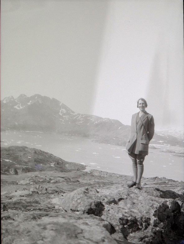 Archive image of Isobel Hutchison standing on a rock in front of a mountain and seascape in Greenland
