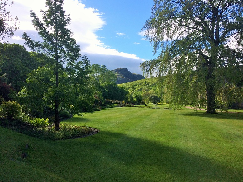 A view of Arthur's Seat from the lush green lawn of the Holyrood Palace gardens 