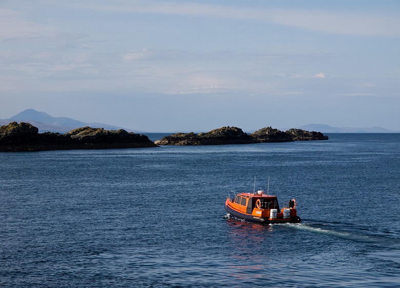A boat on its way to a historic location on an island