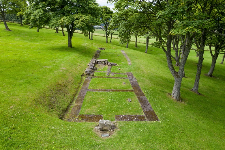 Modern remains of a Roman fort, showing the outline of a building 