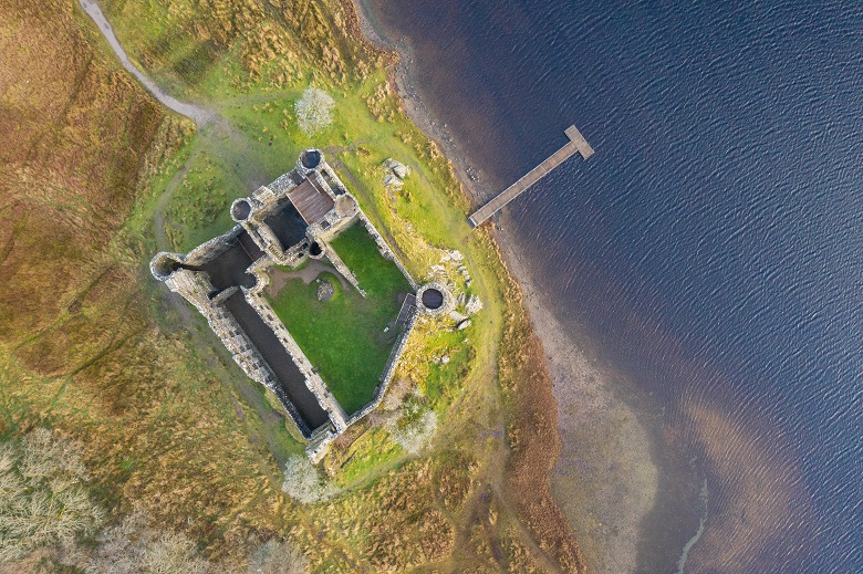 A drone photo taken directly above Kilchurn Castle showing it's stromg walls and multiple towers