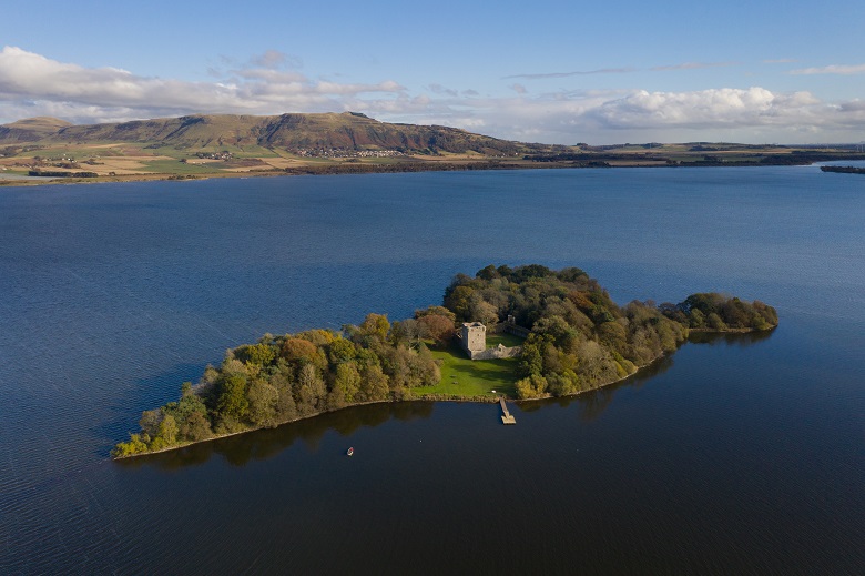 An aerial image of Lochleven Castle showing its location on a small island in the centre of a loch 