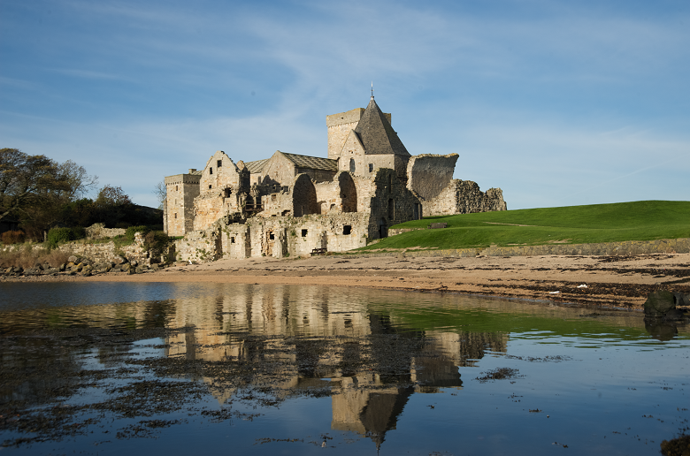 Ruins of an abbey reflected in the sea