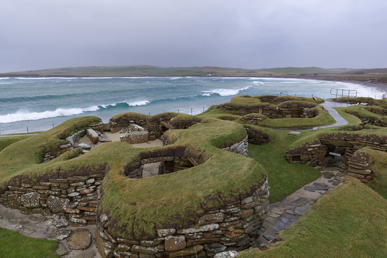 Waves lapping against the shore near the ruins of a prehistoric village