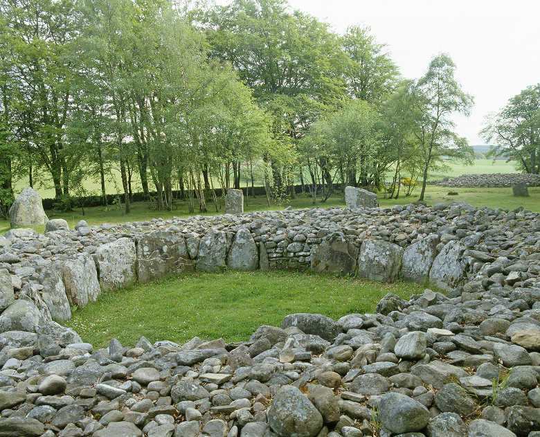 A historic burial cairn surrounded by trees