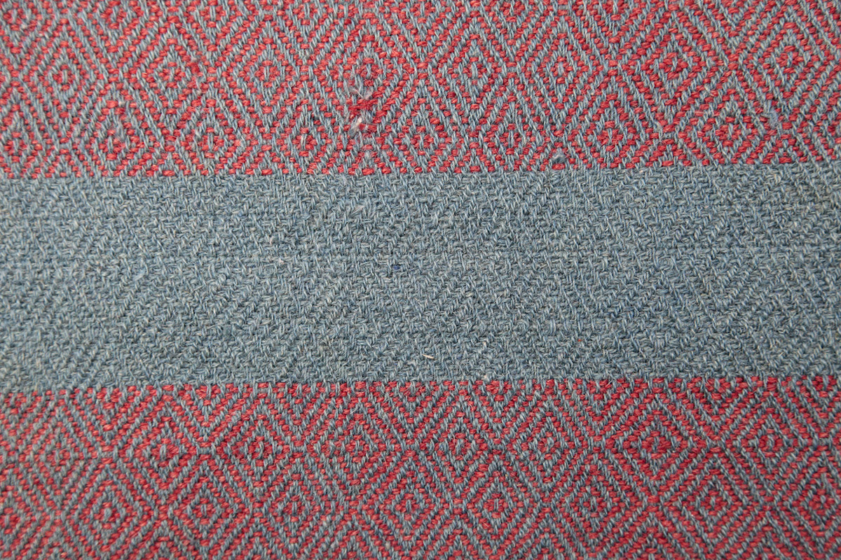 grey and red blanket with diamond pattern