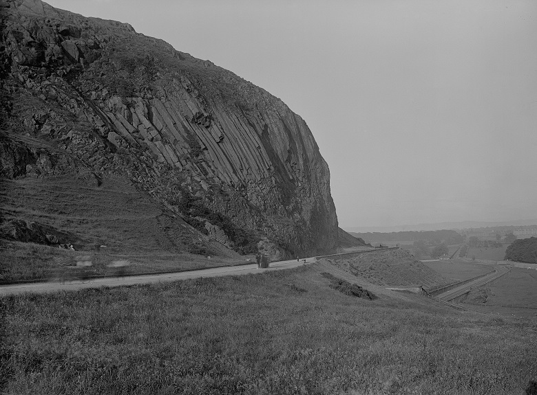 An archive image showing a railway line running along the edge of a park close to rocky crags and a pedestrian path