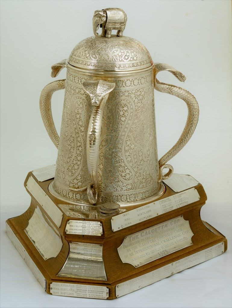 A sporting trophy, decorated with cobra snakes at each corner and an Elephant on top