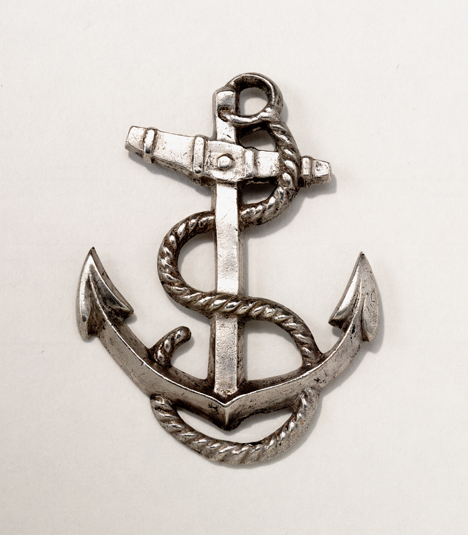 A silver badge in the shape of an anchor entwined with a rope which belonged to a crew member on Erebus or Terror