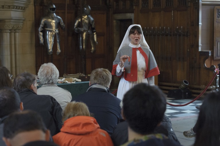 A costumed performer plays the role of a Scottish Women's Hospitals nurse in a living history event in Edinburgh Castle. 