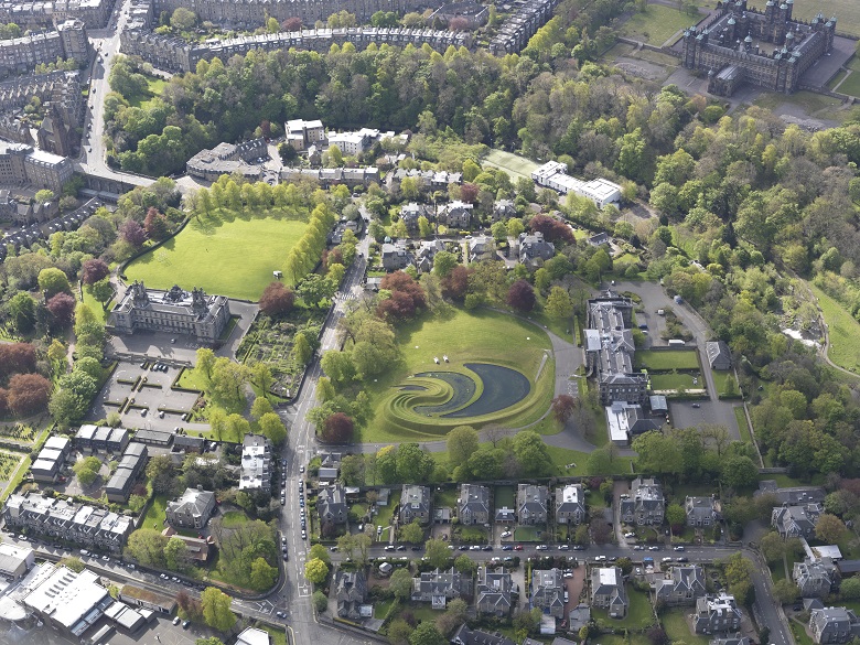 An aerial view of an urban green space, artistically laid out using grass and water at varying levels