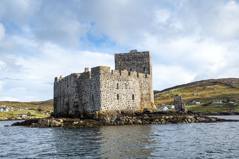 A formidable stone castle built on a small island in a bay