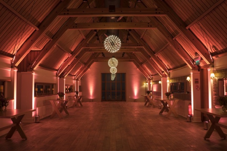 room with sloped ceiling and wooden beams