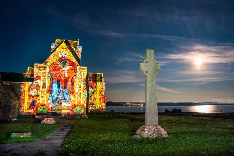 A colourful projection inspired by the pages of the Book of Kells is projected onto an abbey wall