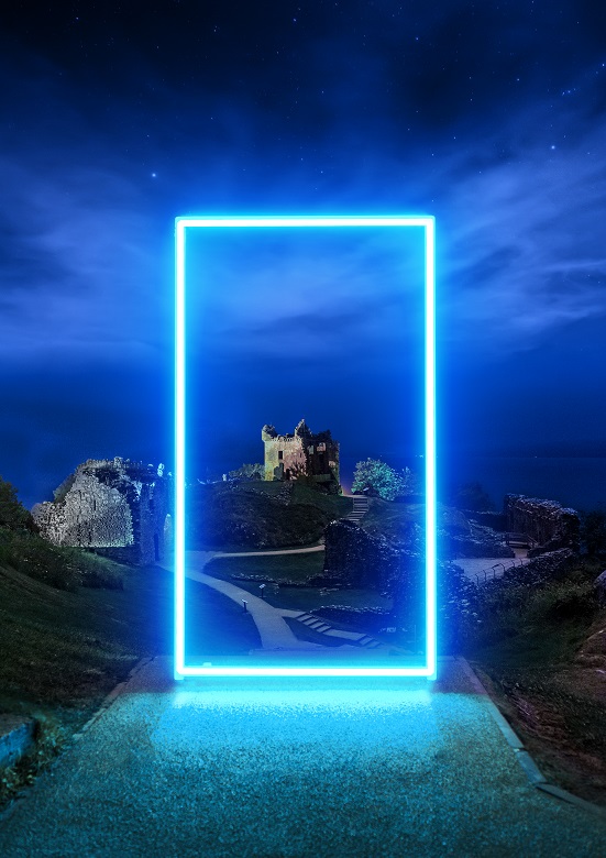 The ruins of a castle at night, framed by a dazzling bright blue projection 