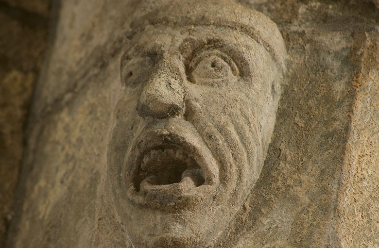 a stone carved grotesque of a screaming man
