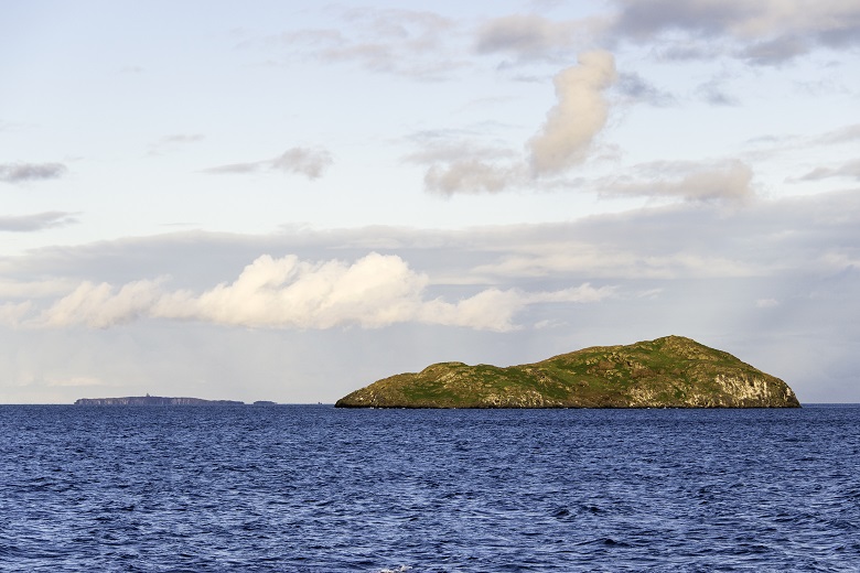 A small island viewed across the waves form a boat