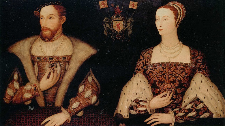 A man with a beard and a woman with her hair pinned up in a formal hairstyle. Both wear very rich clothes with jewels, furs and embroidery. They sit either side of a coat of arms.