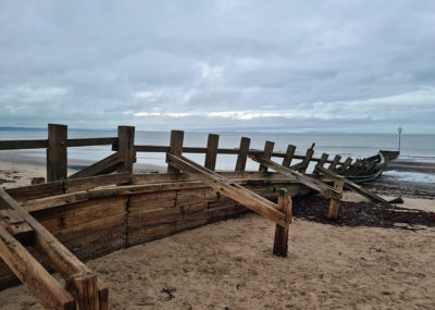Work to build wooden beams to protect the land from sea erosion
