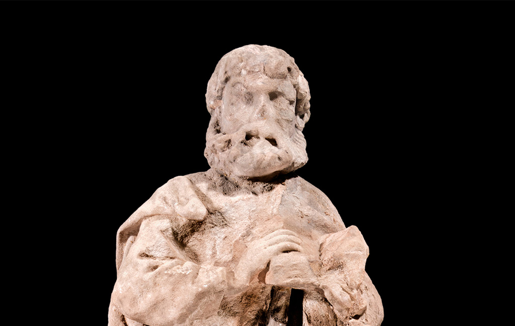 Photo of a statue of a bearded man wearing a robe
