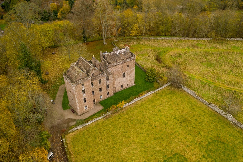 An aerial view of a castle surrounded by fields