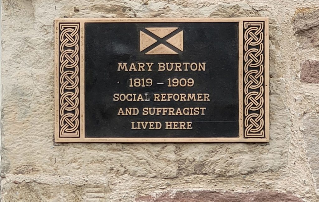 Image of plaque at wall. The plaque reads: "Mary Burton 1819-1909 Social Reformer and Suffragist lived here"