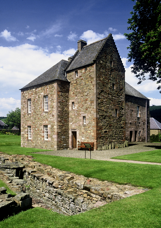 A quirky stone museum building in the grounds of a ruined abbey