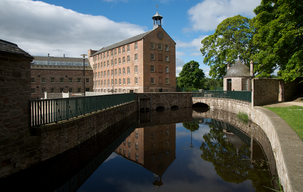 A canal in front of a large mill building at Stanley Mills