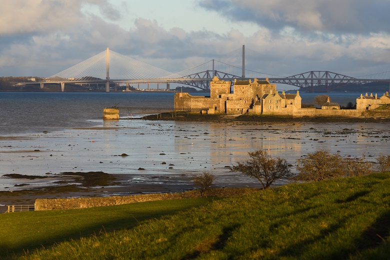 The Forth road and rail bridges seen in the distance behind Blackness Castle