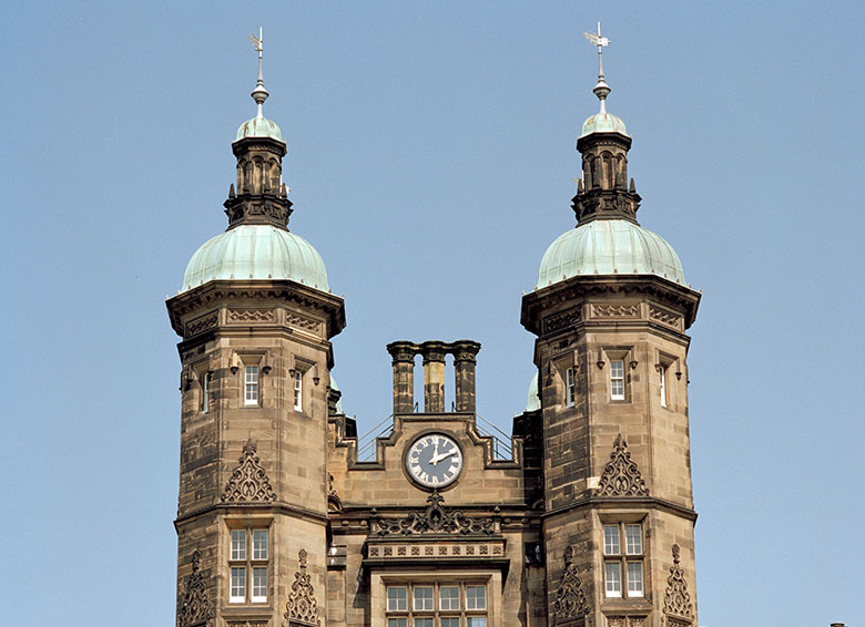 Ornate clock tower, sporting turrets either side.