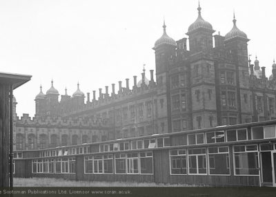 New school buildings in the style of the l950s in formt of the Victorian-era school.