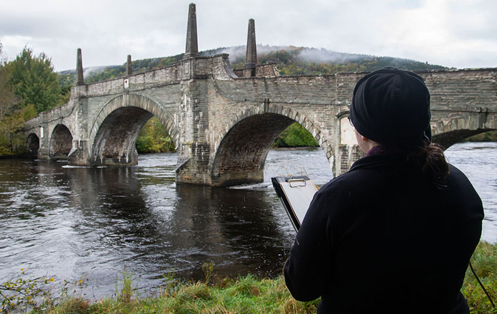 A trainee surveying sections of 18th century military road heritage in Highland Perthshire, including the Wade Bridge in Aberfeldy, Perthshire