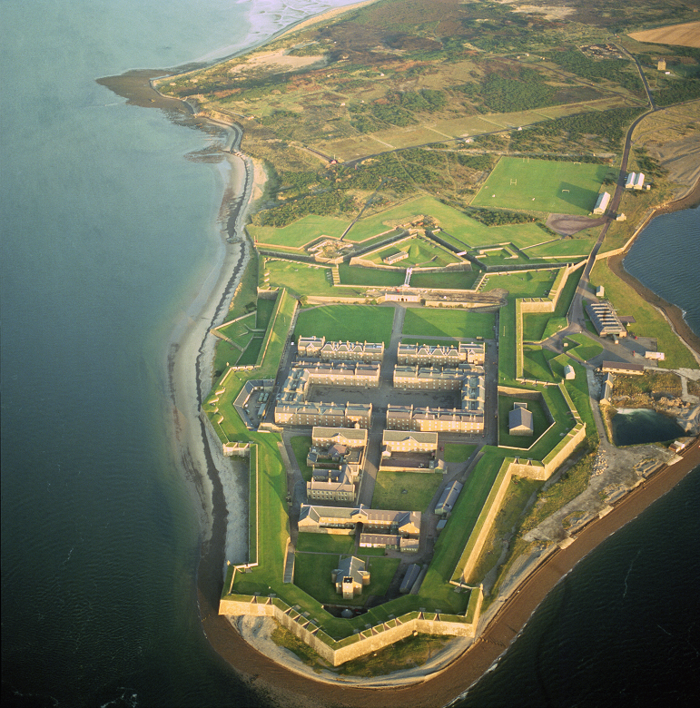 An aerial view of a huge fort, surrounded on three sides by the sea and with formidable star-shaped bastion walls