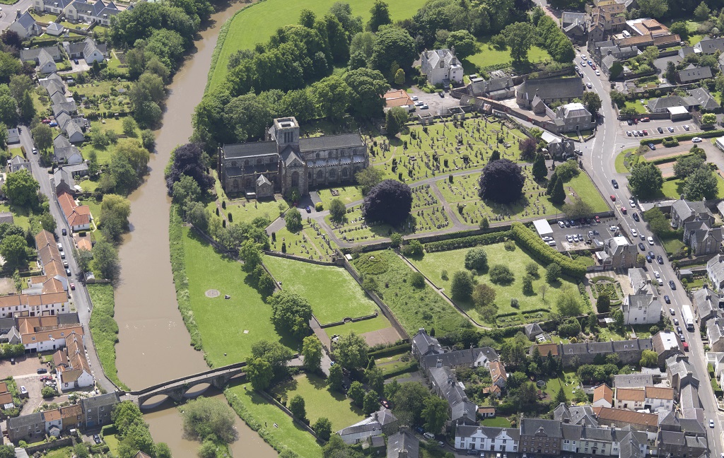 An aerial view of the town of Haddington centring on a medieval church, river and historic bridge