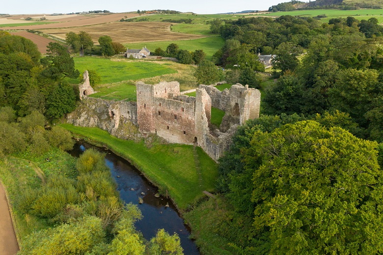 The ruins of a castle nestled in a picturesque location by a river