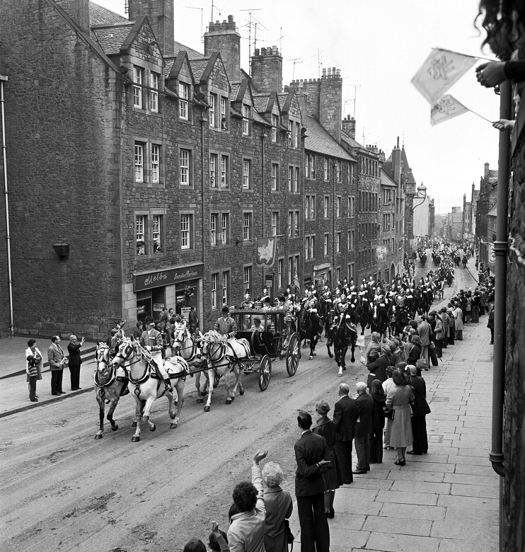 An archive photo of a procession of horses and regal carriages on Edinburgh's Royal Mile