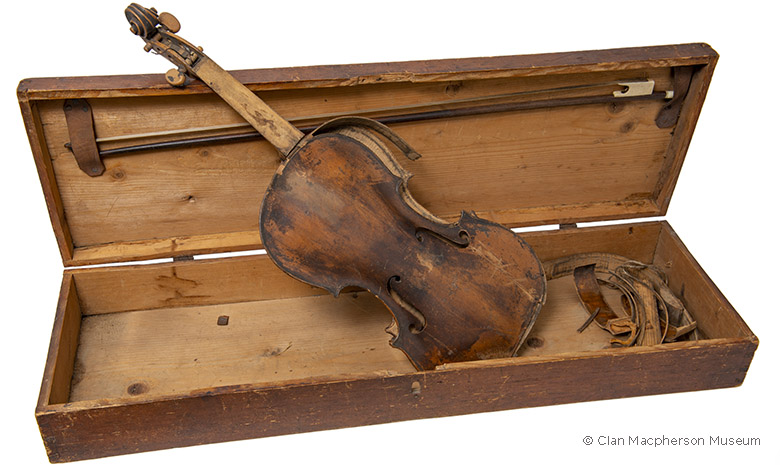 a broken fiddle in a case