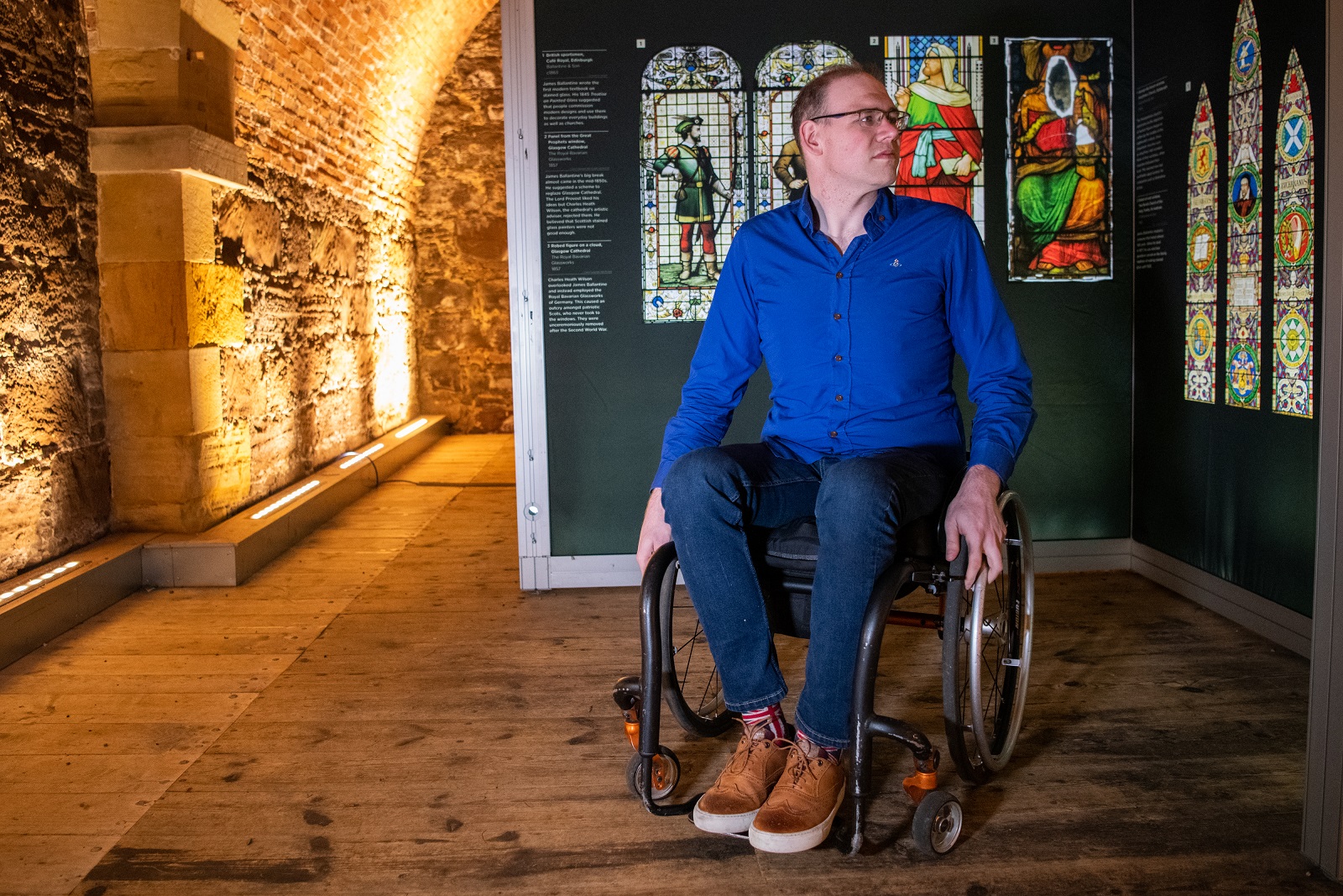 A person sitting in a wheelchair inside Fort George