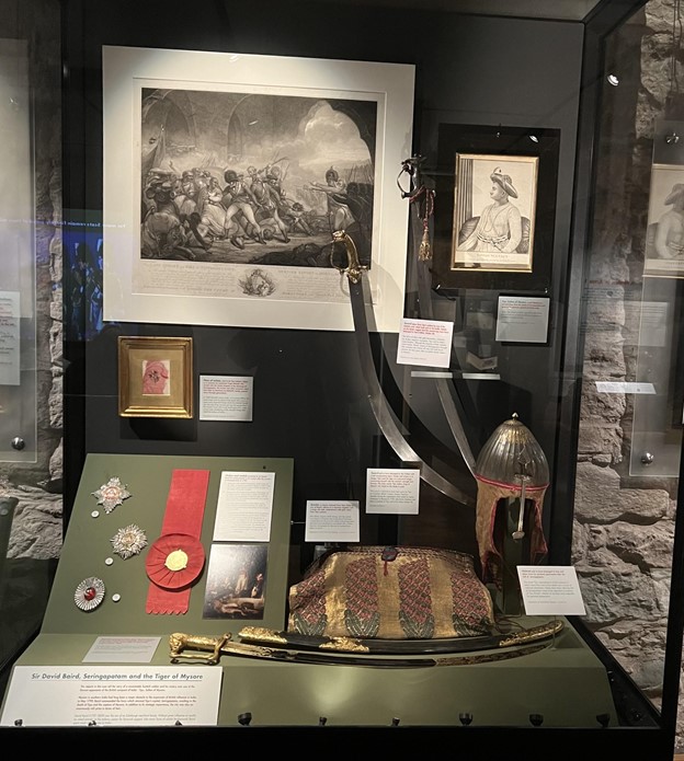 A glass cabinet displaying belongings and items associated with Tipu Sultan