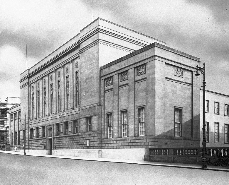 An archive photo of a newly completed National Library of Scotland with large carved figures on the exterior 