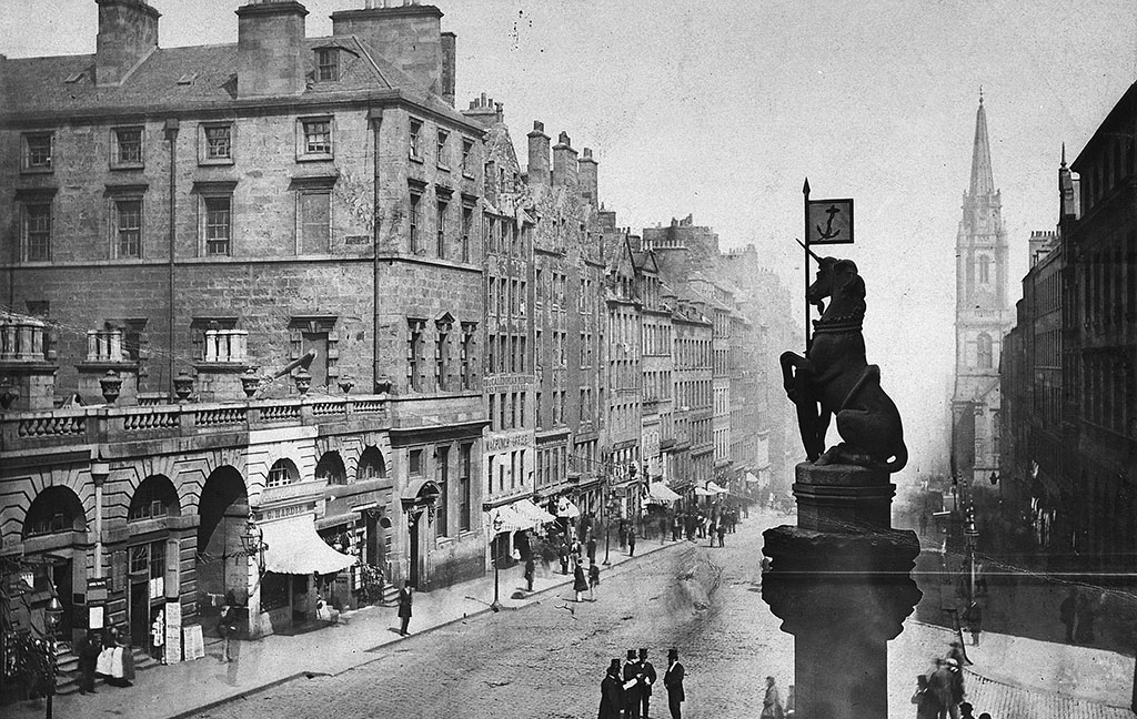 view down Edinburgh's High Street with the unicorn from the Mercat Cross in the foreground