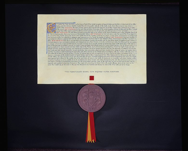 A royal warrant written in medieval style type with a large purple wax seal