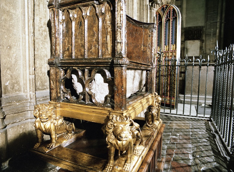 A large, ancient wooden chair with the Stone of Destiny built into a recess under the seat